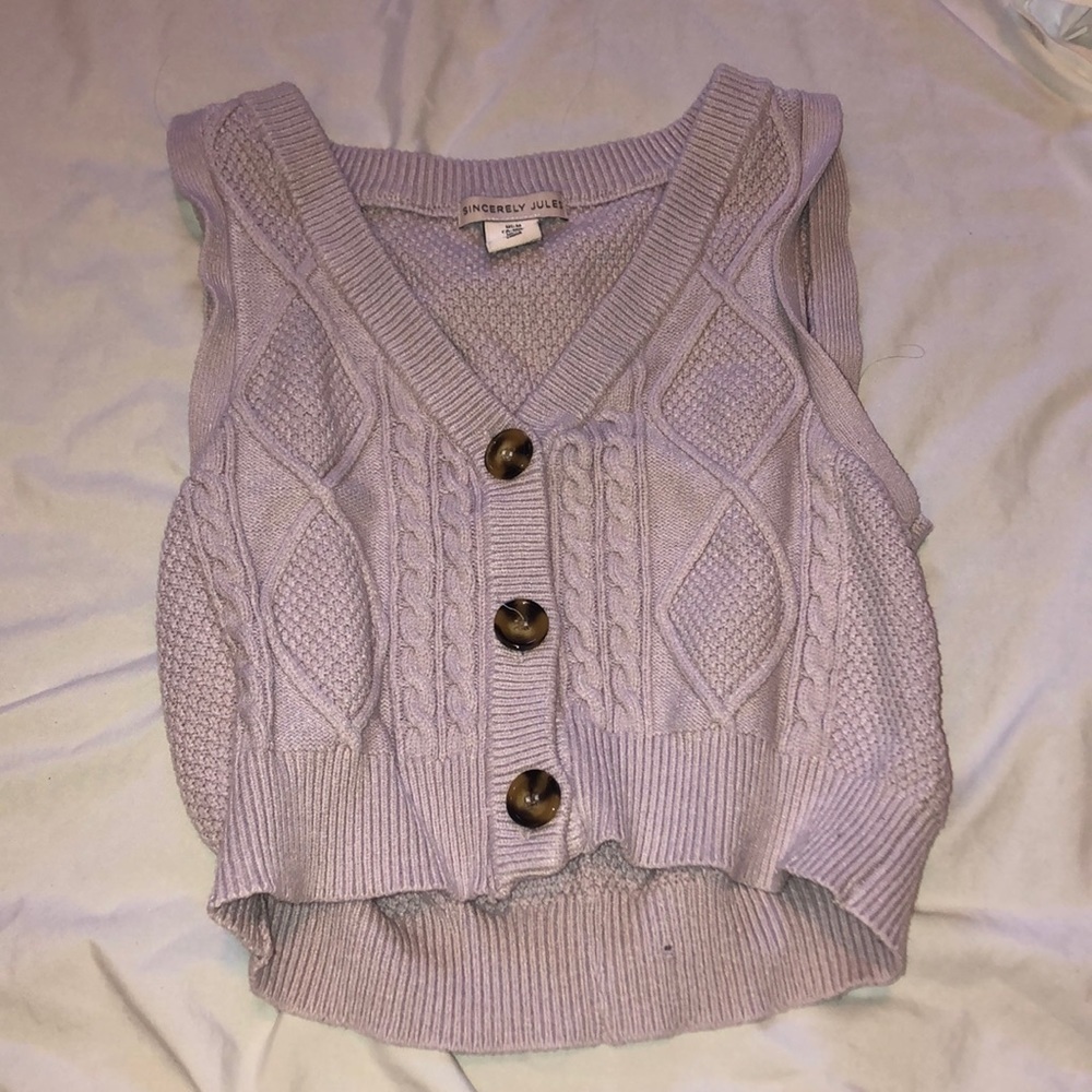 Purple knitted sweater vest with three brown buttons